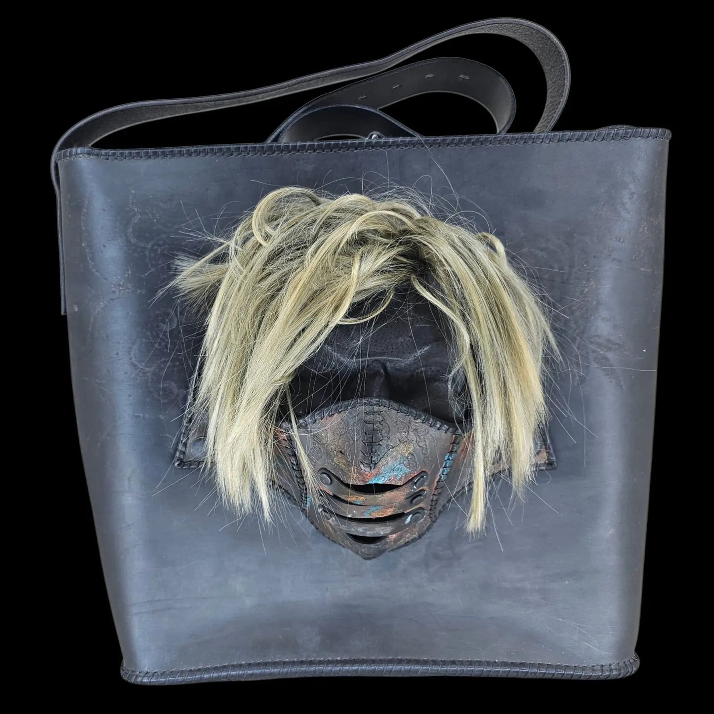 Handmade black leather shoulder bag with an attached 3D sculptural leather mask with metallic and hair-like textures - AG Design, Arad, Romania