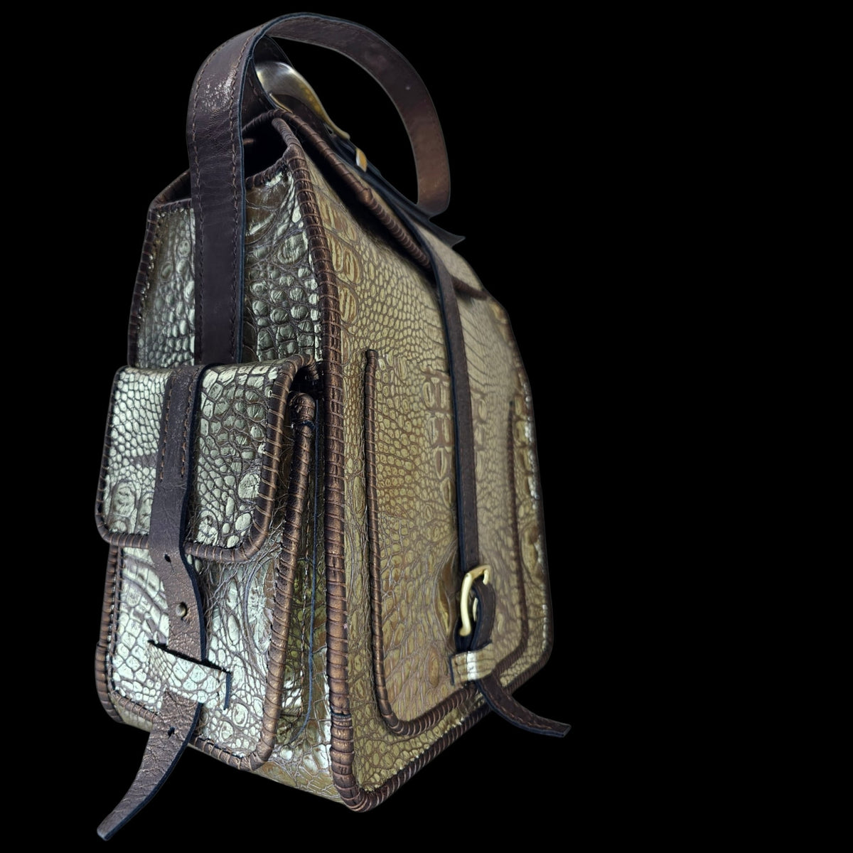 Close-up side profile of a handmade crocodile-embossed leather crossbody bag showing structured silhouette and front pocket - AG Design, Arad, Romania