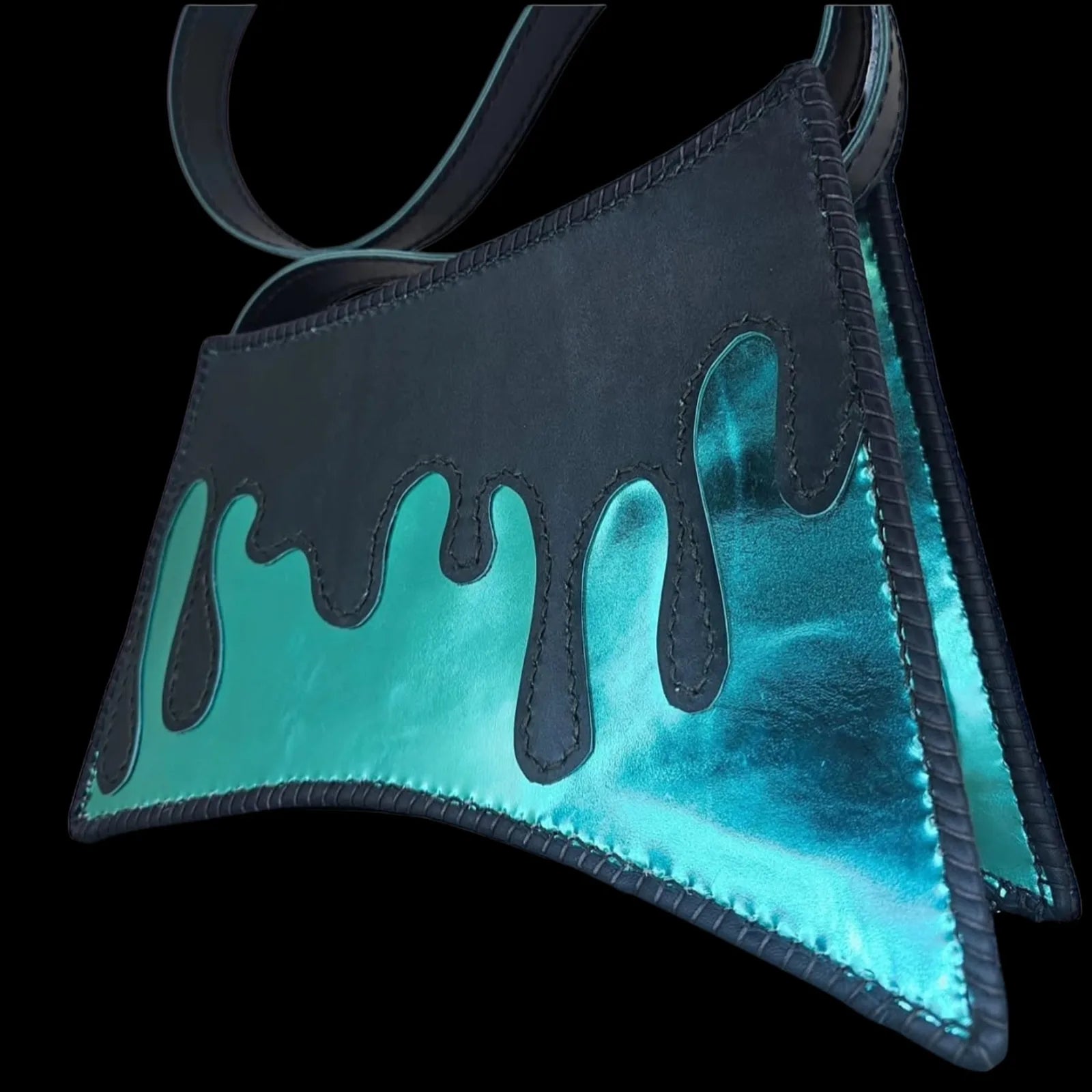 Handmade turquoise leather shoulder bag with a hand-cut asymmetric form revealing a metallic turquoise interior - AG Design, Arad, Romania