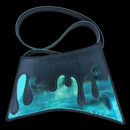 Handmade turquoise leather shoulder bag with a hand-cut asymmetric form revealing a metallic turquoise interior - AG Design, Arad, Romania