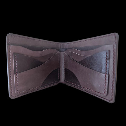 Handmade burgundy leather wallet with a metal medallion of Brancusi's Gate of the Kiss eyes - AG Design, Arad, Romania