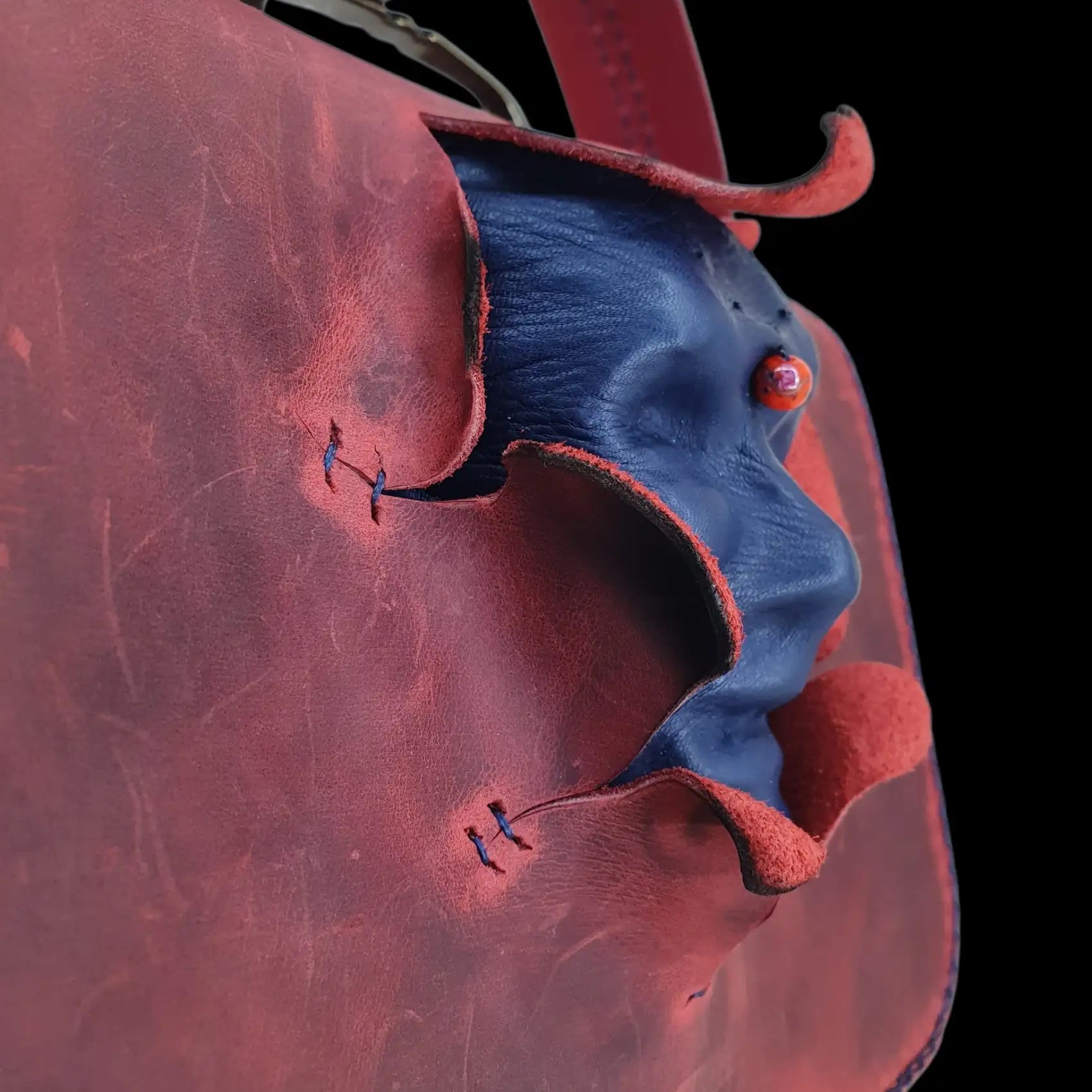 Handmade burgundy leather bag with a blue sculpted 3D face - AG Design, Arad, Romania