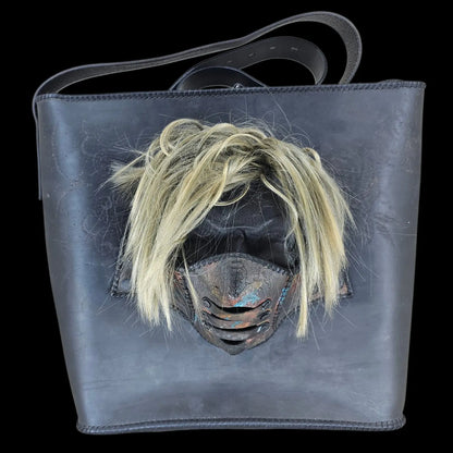 Handmade black leather shoulder bag with an attached 3D sculptural leather mask with metallic and hair-like textures - AG Design, Arad, Romania