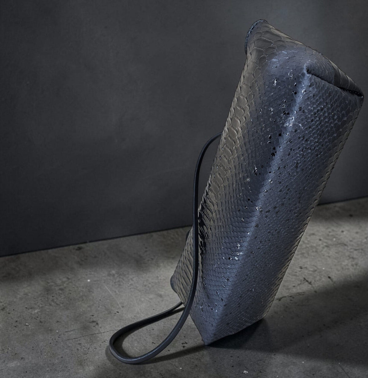 Handmade black leather shoulder bag with shining snake scales and lambskin lining, on a black background - AG Design, Arad, Romania