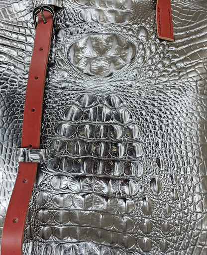 Close-up of the crocodile-embossed leather texture on a handmade silver shoulder bag - AG Design, Arad, Romania.