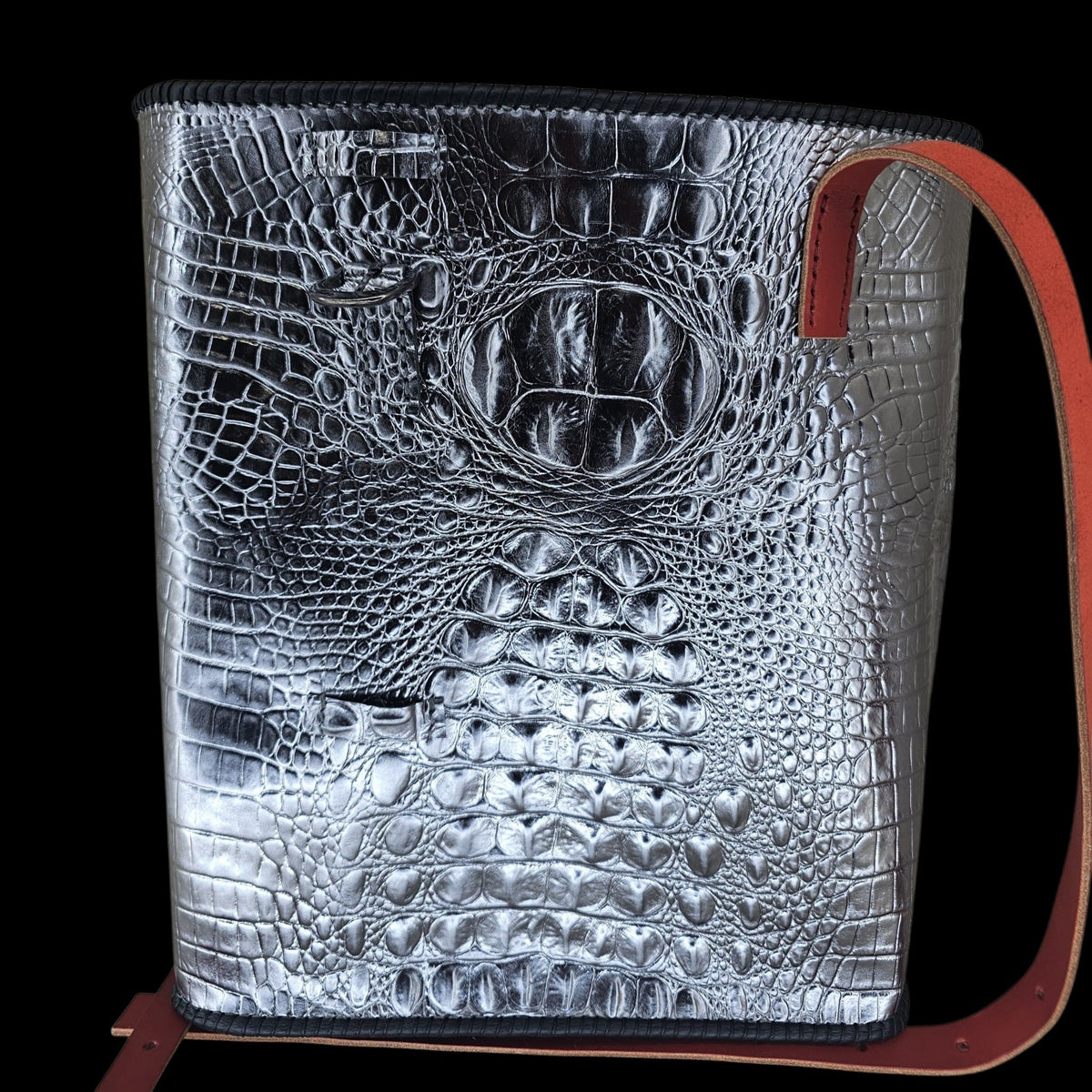 Handmade silver crocodile-embossed leather shoulder bag with the red adjustable strap draped alongside it - AG Design, Arad, Romania.