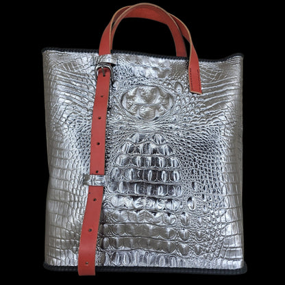 Front view of a handmade silver crocodile-embossed leather shoulder bag with a red adjustable strap - AG Design, Arad, Romania.