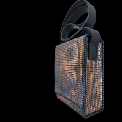 Side view of a handmade grey leather crossbody bag with a hand-stamped copper pattern, strap included - AG Design, Arad, Romania.