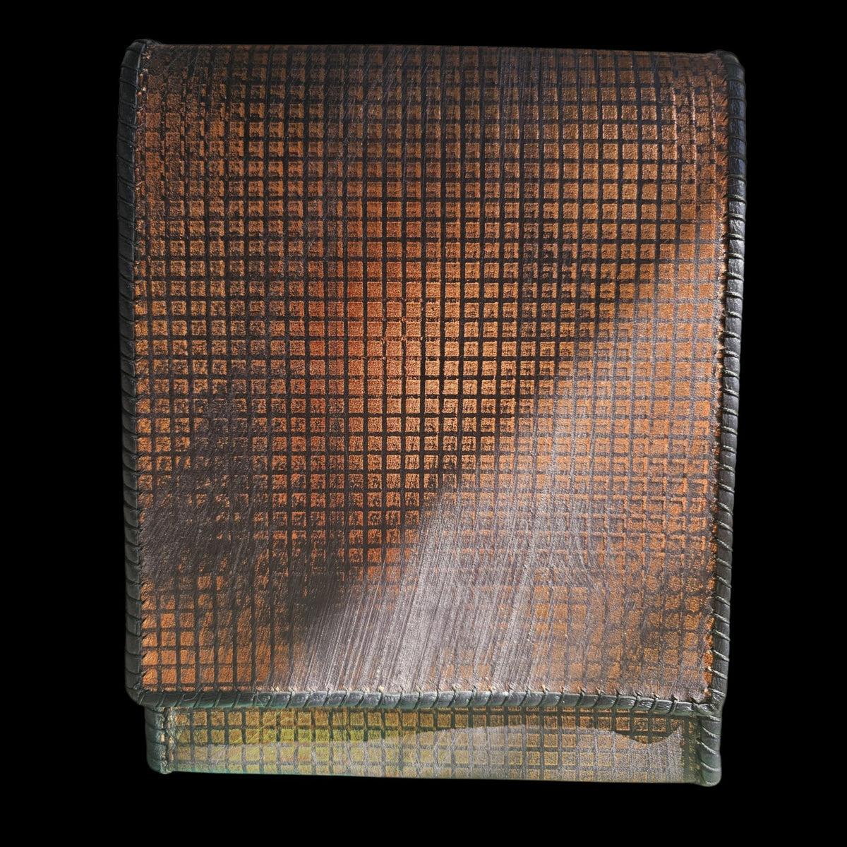 Close-up of the hand-stamped copper grid pattern on a handmade grey leather crossbody bag - AG Design, Arad, Romania.