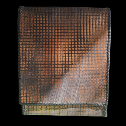 Close-up of the hand-stamped copper grid pattern on a handmade grey leather crossbody bag - AG Design, Arad, Romania.