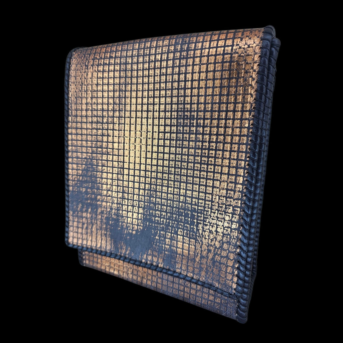 Angled side view of a handmade grey leather crossbody bag with a hand-stamped copper pattern - AG Design, Arad, Romania.
