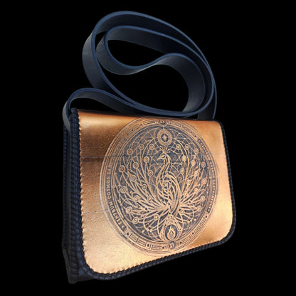 Angled view of a handmade leather crossbody bag with an embossed phoenix medallion - AG Design, Arad, Romania