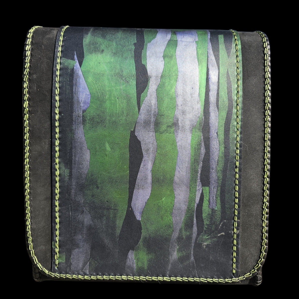 Front flap of a handmade black leather shoulder bag painted in green and grey-navy, framed by green stitching - AG Design, Arad, Romania