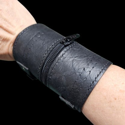 Embossed pattern in the black leather of a handmade cuff wallet, visible only when the light catches it - AG Design, Arad, Romania