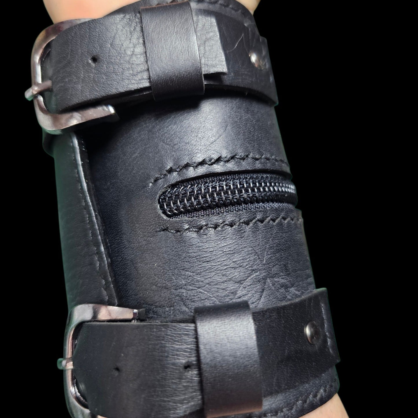 Hand-stitched edge and metal buckle on a handmade black leather cuff wallet - AG Design, Arad, Romania