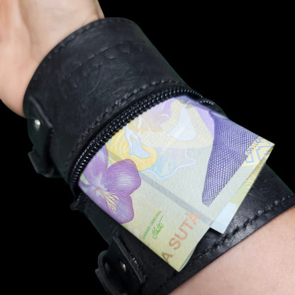Handmade black leather cuff wallet worn on the wrist with a banknote coming out of the hidden zip pocket - AG Design, Arad, Romania