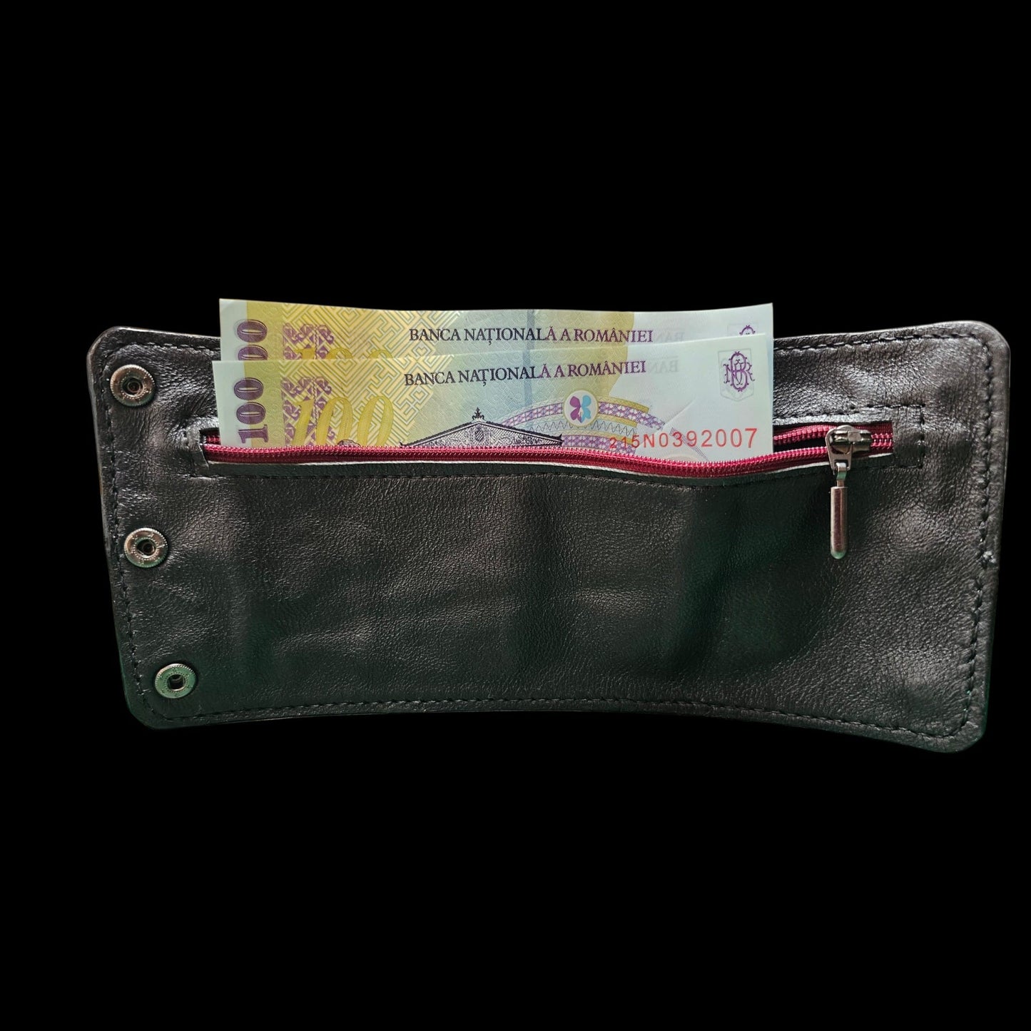 Inside of a handmade leather cuff wallet with the burgundy zip open and banknotes in the pocket - AG Design, Arad, Romania