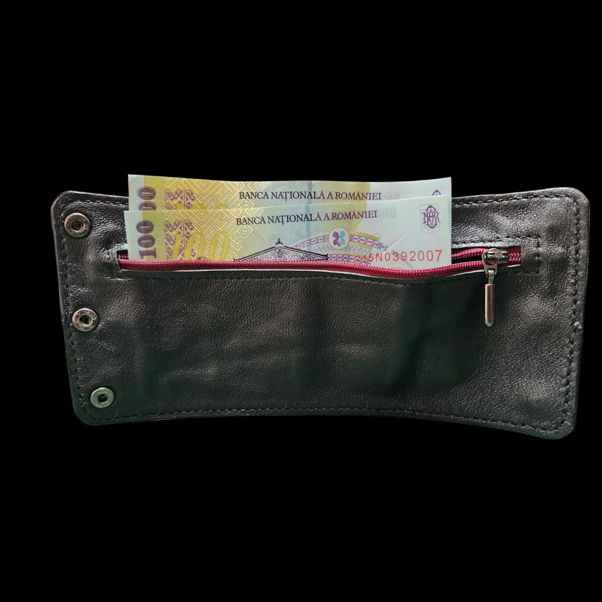 Inside of a handmade leather cuff wallet with the burgundy zip open and banknotes in the pocket - AG Design, Arad, Romania