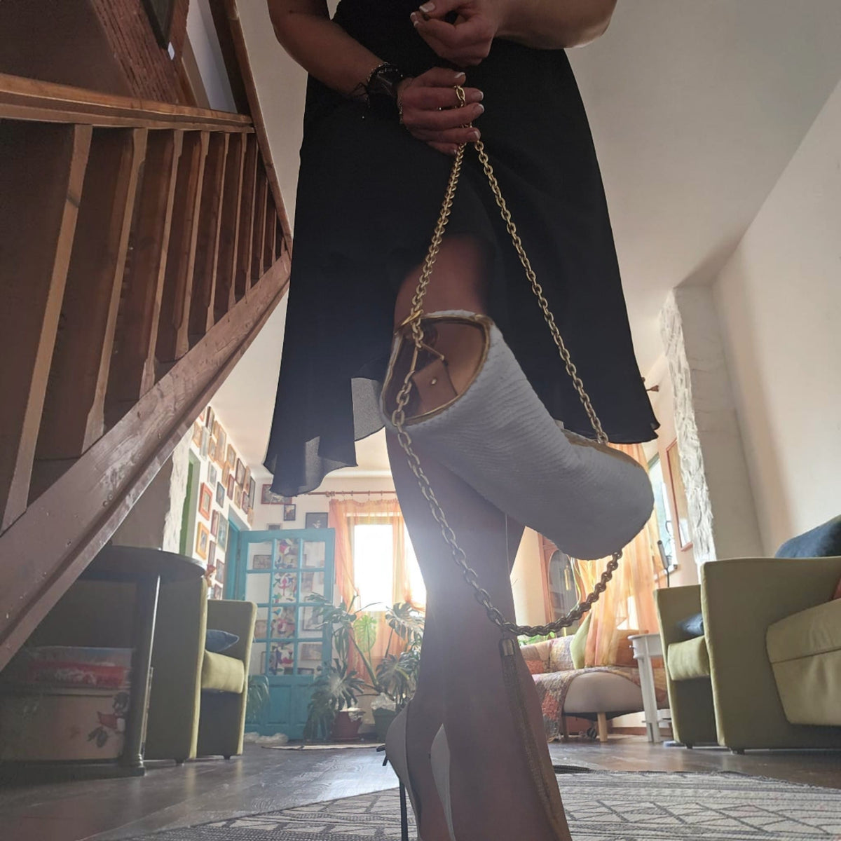 Alexandra holding the handmade white and gold leather barrel bag by its gold-tone chain - AG Design, Arad, Romania