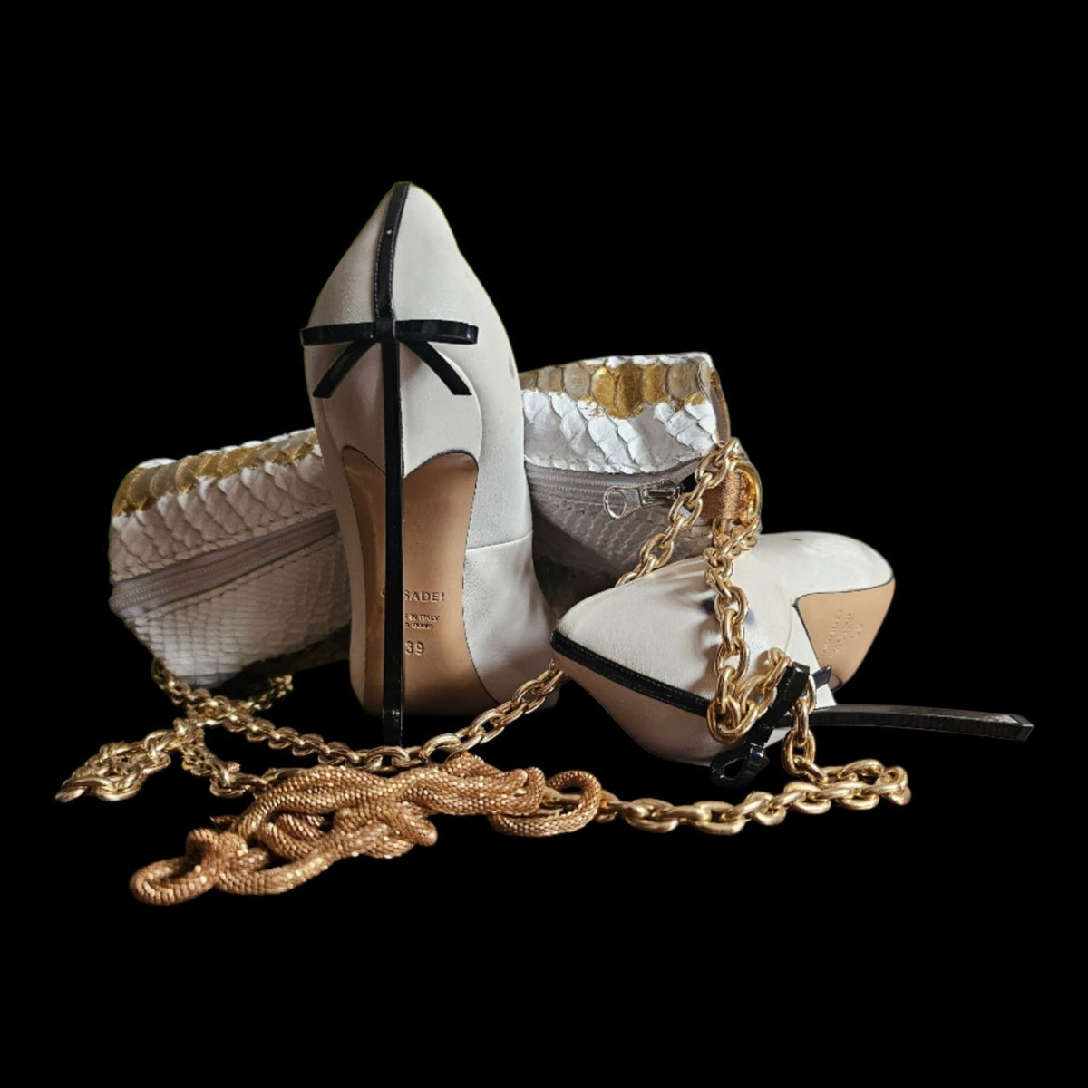 Handmade white and gold crocodile-embossed leather barrel bag with its gold-tone chain, arranged with white heels on a black background - AG Design, Arad, Romania