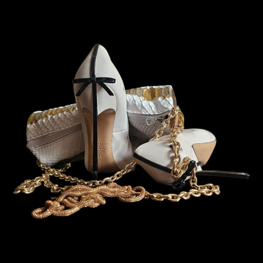 Handmade white and gold crocodile-embossed leather barrel bag with its gold-tone chain, arranged with white heels on a black background - AG Design, Arad, Romania