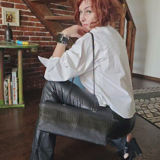 Video of the handmade black snake-embossed leather shoulder bag catching the light - AG Design, Arad, Romania