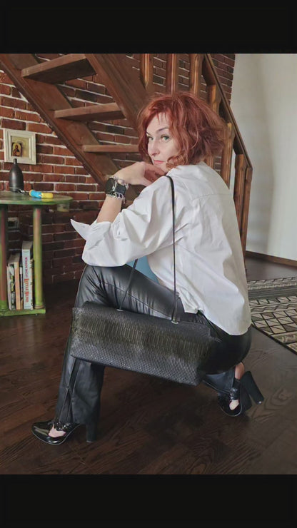 Video of the handmade black snake-embossed leather shoulder bag catching the light - AG Design, Arad, Romania