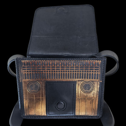Close-up of the front of a handmade leather shoulder bag with the flap lifted, showing the embossed interior - AG Design, Arad, Romania
