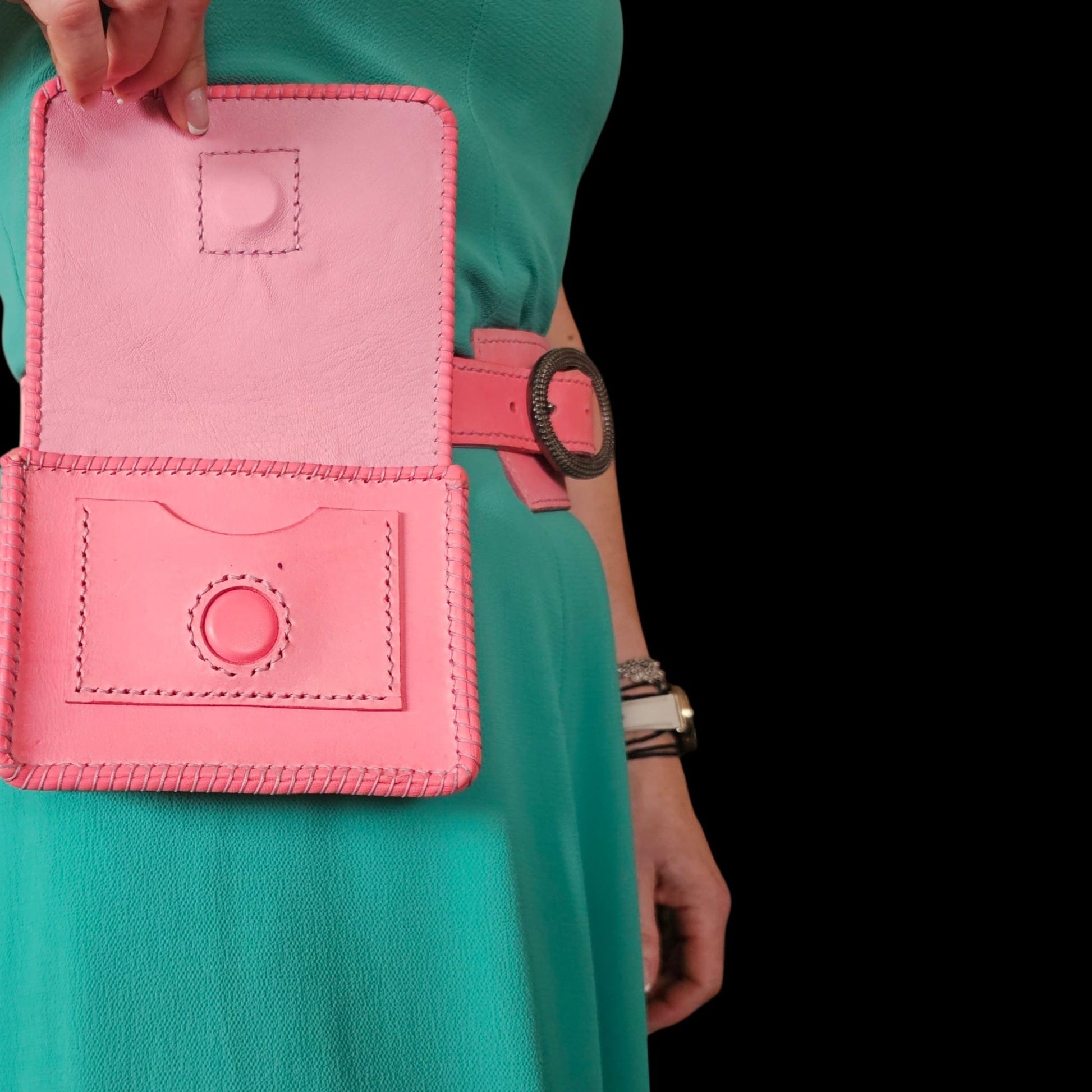 The pouch of a handmade pink leather belt held open, showing the card slot and the leather-covered snap - AG Design, Arad, Romania