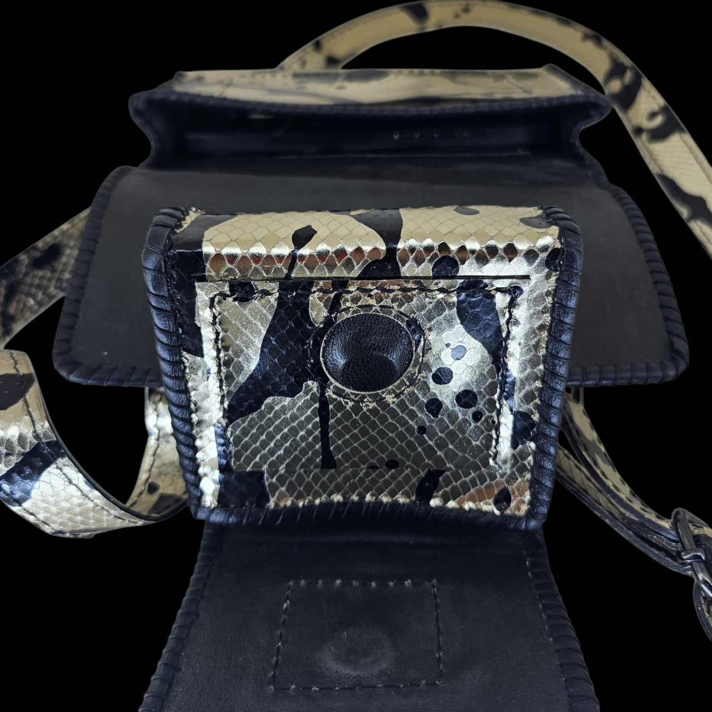 Open small pouch showing the black leather lining and magnetic closure of a handmade leather crossbody bag - AG Design, Arad, Romania