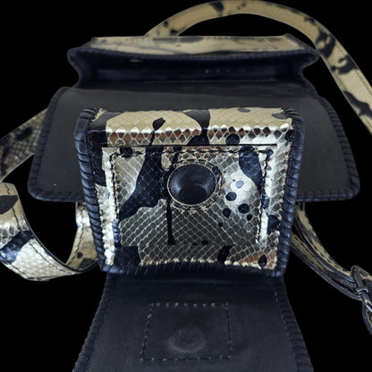Open small pouch showing the black leather lining and magnetic closure of a handmade leather crossbody bag - AG Design, Arad, Romania