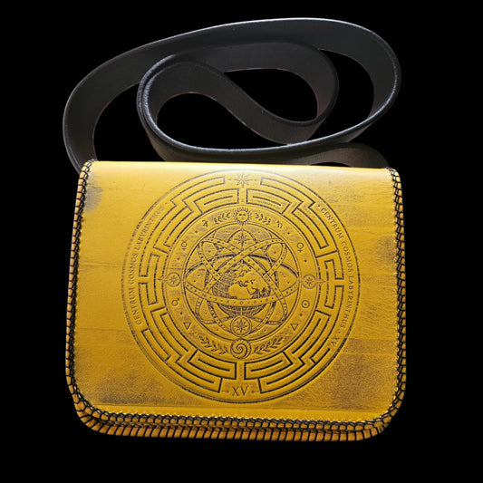 Handmade mustard yellow leather crossbody bag seen from the front with its fixed strap laid above it - AG Design, Arad, Romania