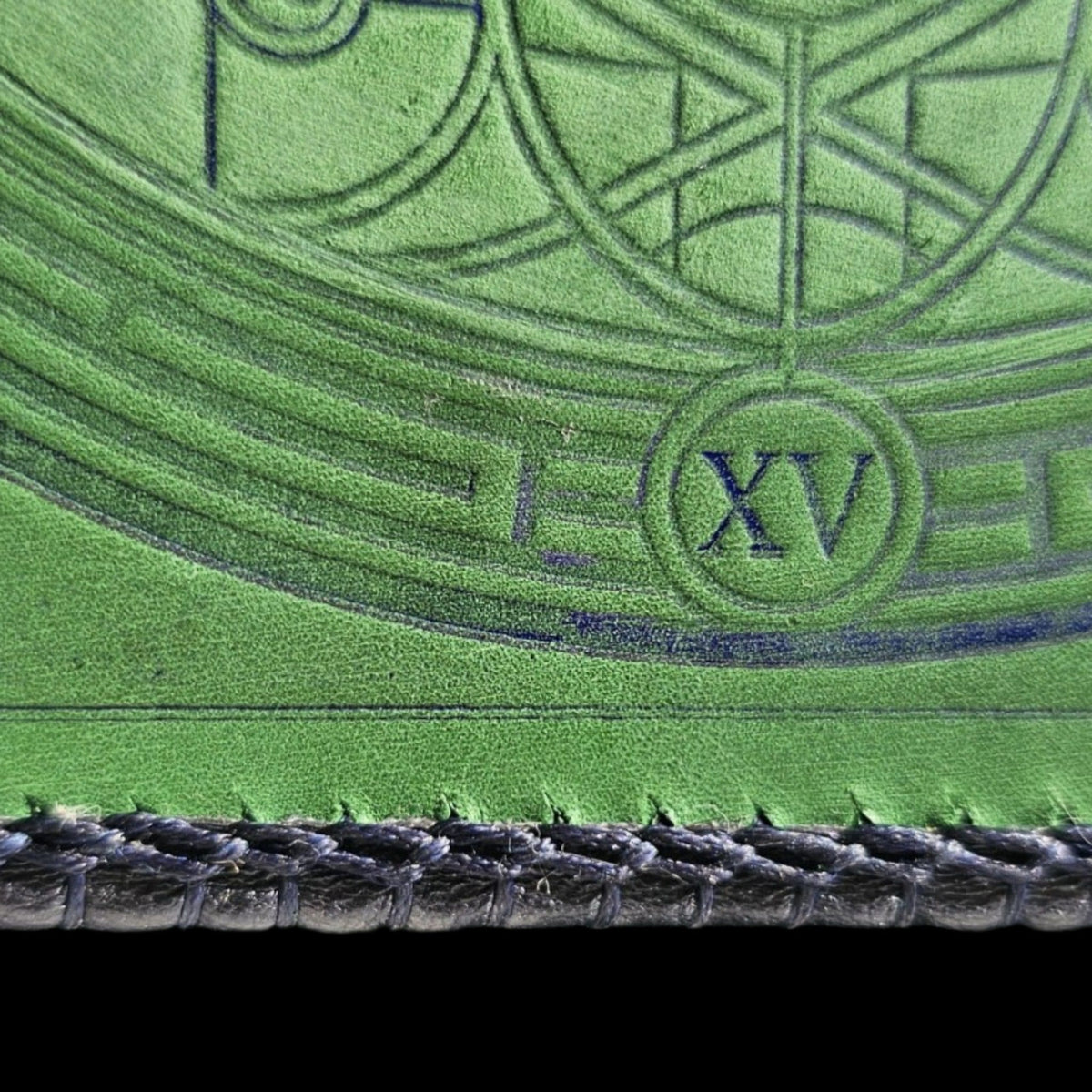 Detail of the Roman numeral XV and the navy laced edge on a handmade green leather crossbody bag - AG Design, Arad, Romania