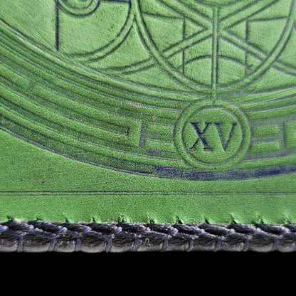Detail of the Roman numeral XV and the navy laced edge on a handmade green leather crossbody bag - AG Design, Arad, Romania
