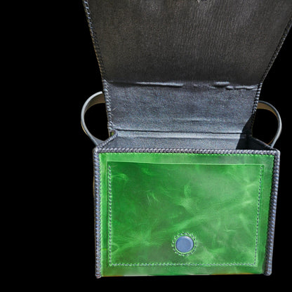 Open handmade green leather crossbody bag showing the lambskin lining and inner pockets - AG Design, Arad, Romania
