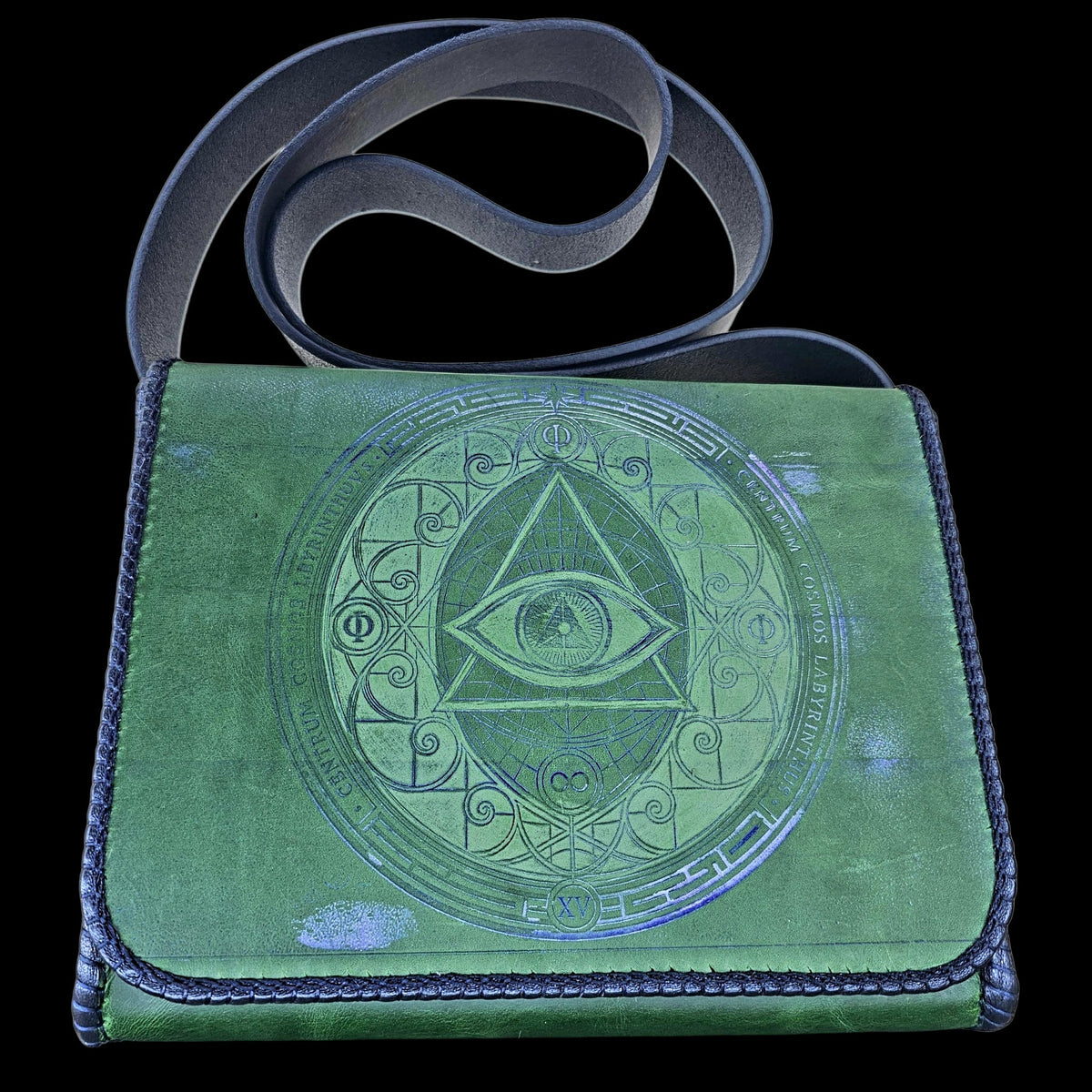 Handmade green leather crossbody bag with blue-embossed sacred geometry and a navy strap, seen from the front - AG Design, Arad, Romania